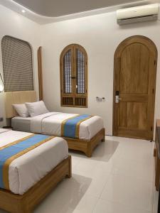 Postel nebo postele na pokoji v ubytování Hotel Besar Purwokerto + 37 fotografií