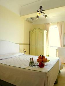 a bedroom with a bed with a plate of fruit on it at Locanda Degli Agrumi in Conca dei Marini