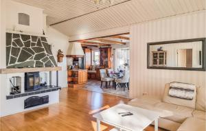 a living room with a couch and a fireplace at Lovely Home In Uddevalla With Kitchen in Uddevalla