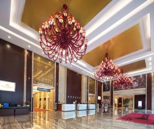a lobby with two large pink chandeliers at United Kingson HoteL in Chengdu