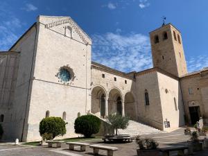 a church with a tower and a cross on top at Clara Luna appartamento turistico in Osimo