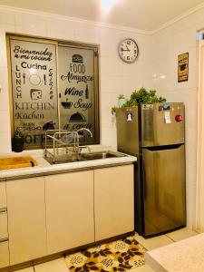 a kitchen with a stainless steel refrigerator and a sink at Casas Lindas y acogedoras "PAQARI" in Vallenar