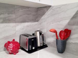 a kitchen counter with a coffee maker and a toaster at Beachside One Bedroom Flat Retreat in Maroochydore