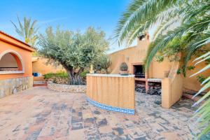 a courtyard in a house with a palm tree at Maria I Apartment with private pool in Torrevieja