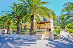 a house with palm trees in front of it at NEO - sea view villa with private pool in Moraira in Teulada