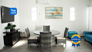 a dining room with a table and chairs and a couch at Casa San blas Islitas 60 in San Blas