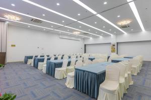 a conference room with blue tables and white chairs at Xixi Nanlu Ssaw Boutique Hotel in Hangzhou