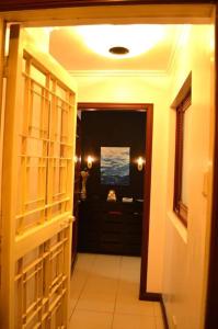 a hallway leading to a bathroom with a room with atained at Makati Huge & Cozy Home w/Carpark in CBD; FibrWifi in Manila