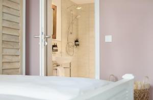 a bathroom with a shower and a white sink at Beach Apartments Büsum in Büsum