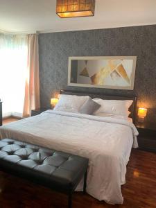 a bedroom with a large bed with white sheets and pillows at Makati Huge & Cozy Home w/Carpark in CBD; FibrWifi in Manila