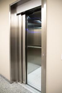 a glass elevator door in a building at Appartamenti Del Borgo in Borgosesia