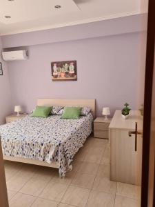 a bedroom with a bed and a cross on the wall at Panorama Beach House in Mascali +75 photos