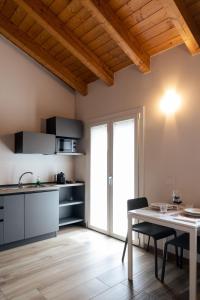a kitchen and dining room with a table and chairs at Appartamenti Del Borgo in Borgosesia