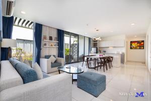 a living room with a couch and a table at MIA Beach Villa - Oceanami Resort Long Hai Vung Tau in Long Hai