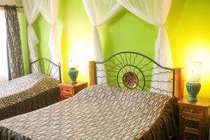 a bedroom with two beds and two lamps on tables at Khweza Bed and Breakfast in Nairobi