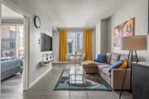 a living room with a couch and a table at City View 1BR Downtown Calgary in Calgary