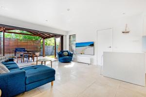 a living room with a blue couch and a table at Palm Beach Haven in Gold Coast