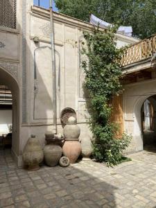 a group of vases sitting next to a building at Emir in Bukhara