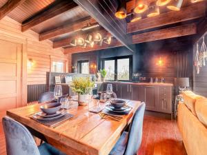 a dining room with a wooden table and chairs at Little Yew Tree Lodge in Hambledon