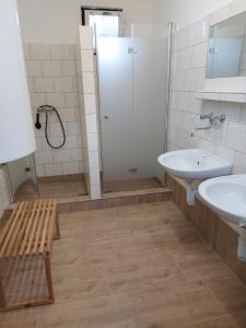 a bathroom with two sinks and a shower at ZÁTOKA Živohošť - Chaty in Chotilsko