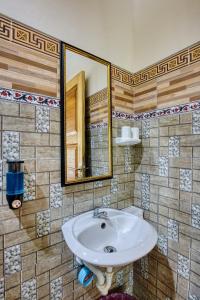a bathroom with a sink and a mirror at Tegal Besung Cottage in Nusa Penida