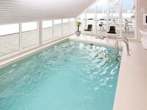 a large swimming pool in a house with a tub at Holiday Home Foreneset in Jelsa