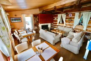 a living room with white furniture and a fireplace at Penzion U Kotle in Horni Misecky