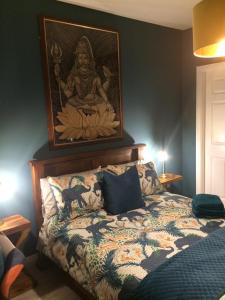 a bedroom with a bed with a painting on the wall at Applelea House in Rosslare