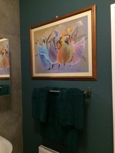 a bathroom with a painting of dancers on the wall at Applelea House in Rosslare