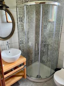 a bathroom with a shower and a sink at Kouremenos Beach Apartments in Palekastron