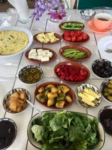 a table with many plates of food on it at Çıralı Marina Loft in Cıralı