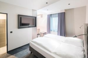 Cama ou camas em um quarto em Hotel Cult Frankfurt City