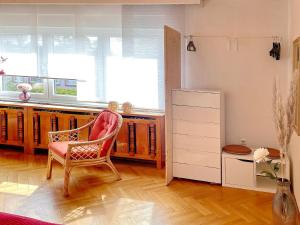 a room with a chair and a desk and a refrigerator at Ferienwohnung Wildbiene in Lübbenau