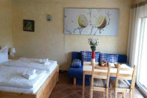 a bedroom with a bed and a table and chairs at Ferienhäuschen Hochufer in Lohme +5 photos