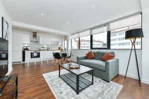 ein Wohnzimmer mit einem Sofa und einem Tisch in der Unterkunft Carlton Heights - A beautiful, inviting and modern 2 bedroom apartment, perfect for corporate stays and leisure in Nottingham