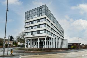 a tall white building on the corner of a street at Carlton Heights - A beautiful, inviting and modern 2 bedroom apartment, perfect for corporate stays and leisure in Nottingham
