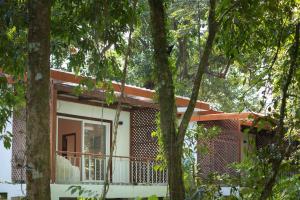a house with a balcony in the woods at La Passion by Achariyak in Koh Rong Sanloem