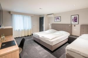 Cama ou camas em um quarto em Hotel Cult Frankfurt City