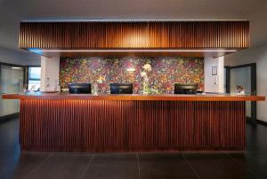 a bar in a restaurant with a colorful wall at Hotel Cult Frankfurt City in Frankfurt