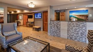 a lobby with a bar and chairs and a tv at Best Western Chincoteague Island in Chincoteague