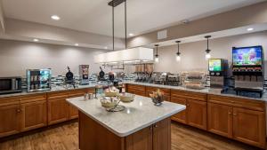 a large kitchen with wooden cabinets and a counter top at Best Western Chincoteague Island in Chincoteague