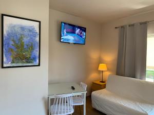 a bedroom with a bed and a tv on the wall at Studio 28 3ου ορόφου στο Χαλάνδρι in Athens