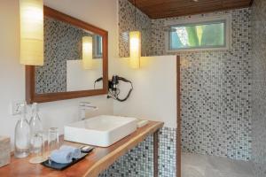 a bathroom with a sink and a mirror at La Passion by Achariyak in Koh Rong Sanloem