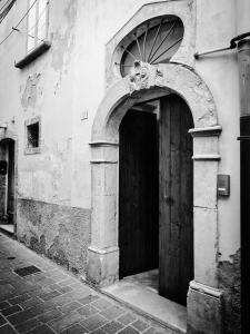 a black and white photo of a building with a door at Antica Dimora 1848 in Biccari