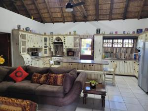 a living room with a couch and a kitchen at Alamo Guest Farm in Warmbaths