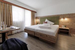 A bed or beds in a room at Hotel Neuwirt