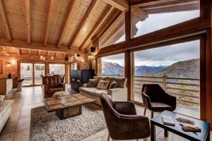 a living room with a view of a mountain at Chalet le Cerf in La Tzoumaz