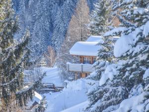 a cabin in the woods with snow on the trees at Chalet le Cerf in La Tzoumaz