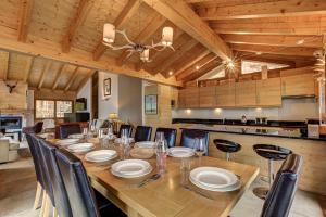 a dining room with a long table and chairs at Chalet le Cerf in La Tzoumaz +19 photos