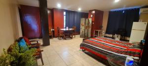 a bedroom with a bed and a table and chairs at Palau Paradise Comfort in Koror